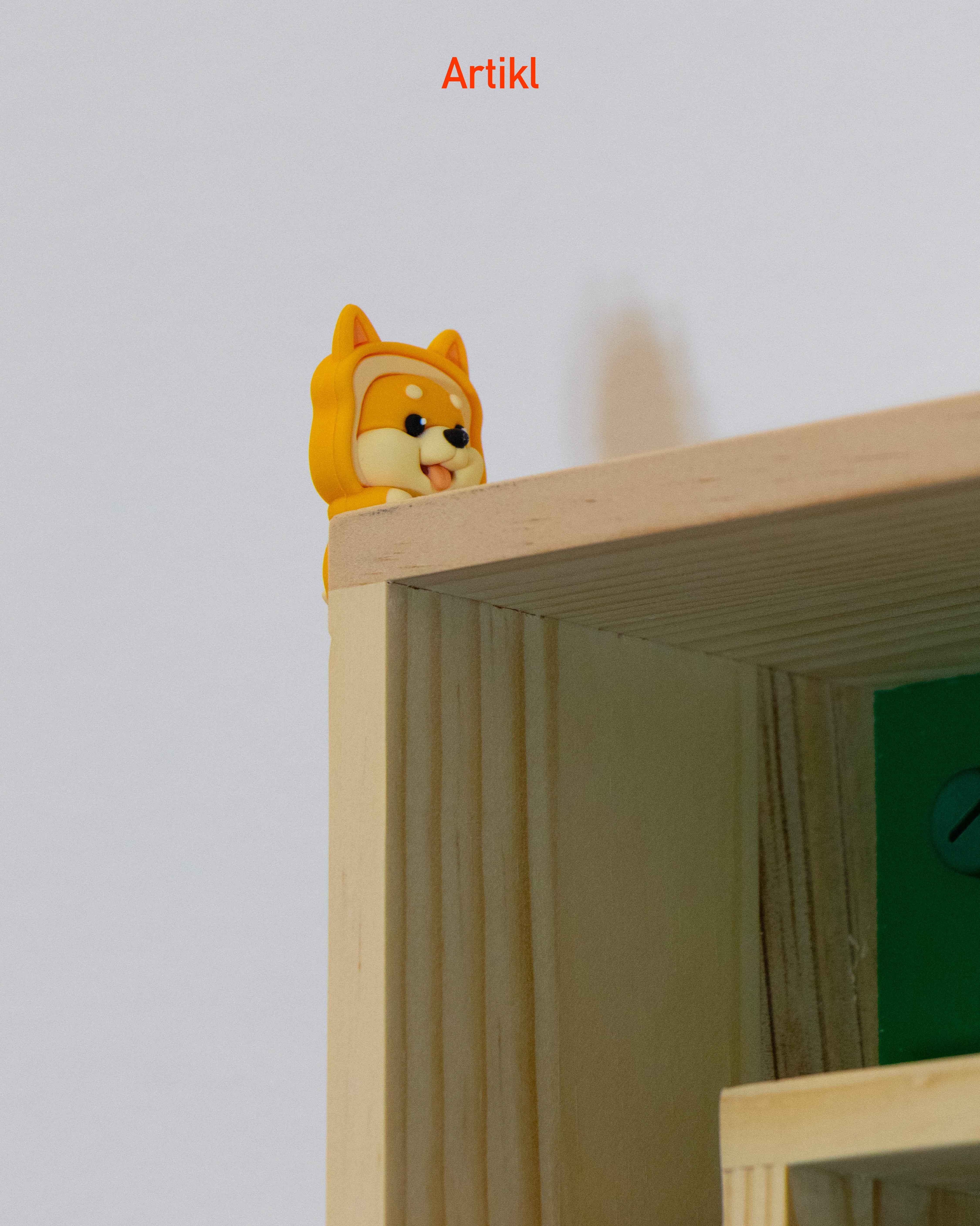 Peek-a-Pals Shiba Puppy phone peeker figure attached to a shelf edge, cute dog desk accessory and gift for dog lovers