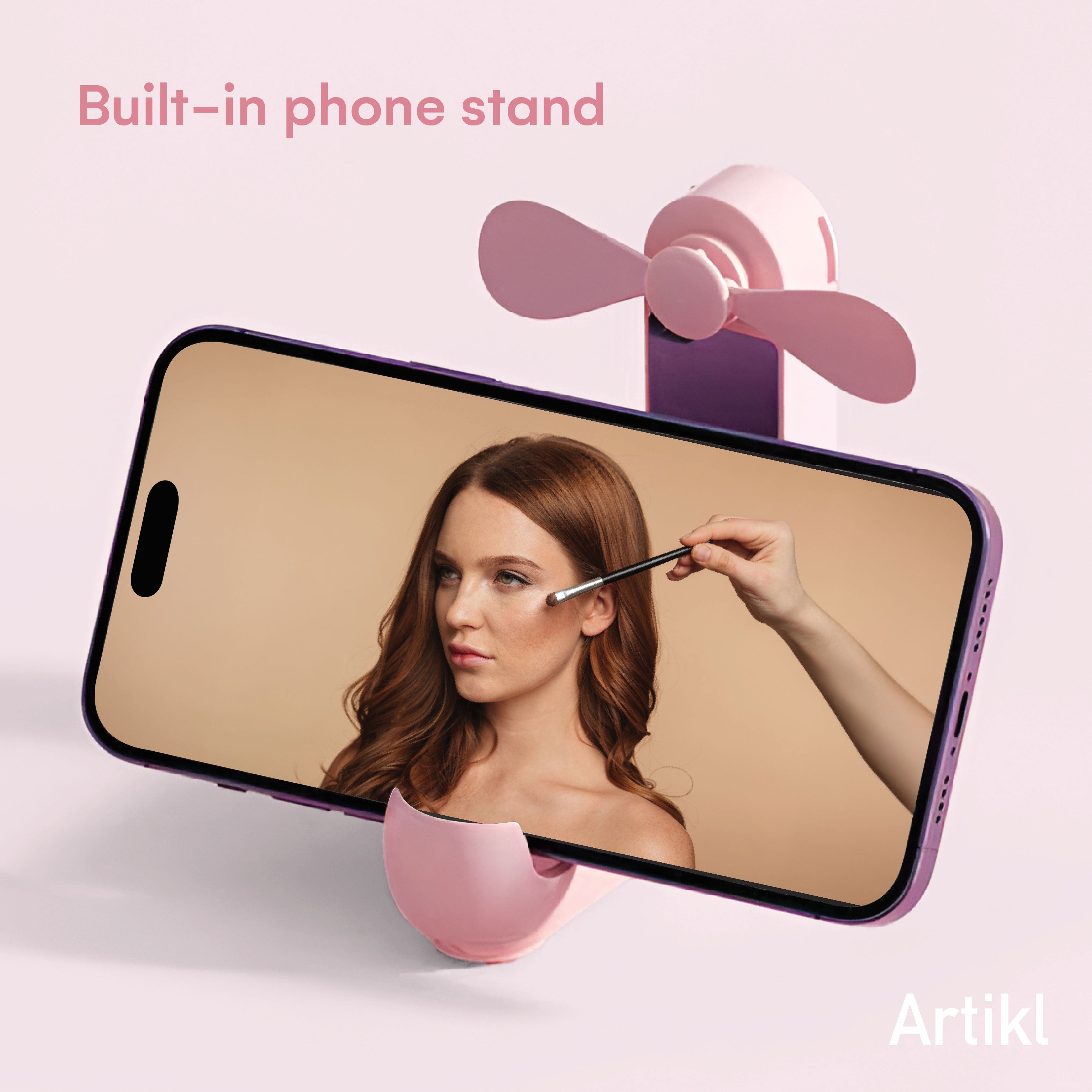 Foldable Handheld Fan with built-in phone stand holding a phone at an angle for hands-free makeup application