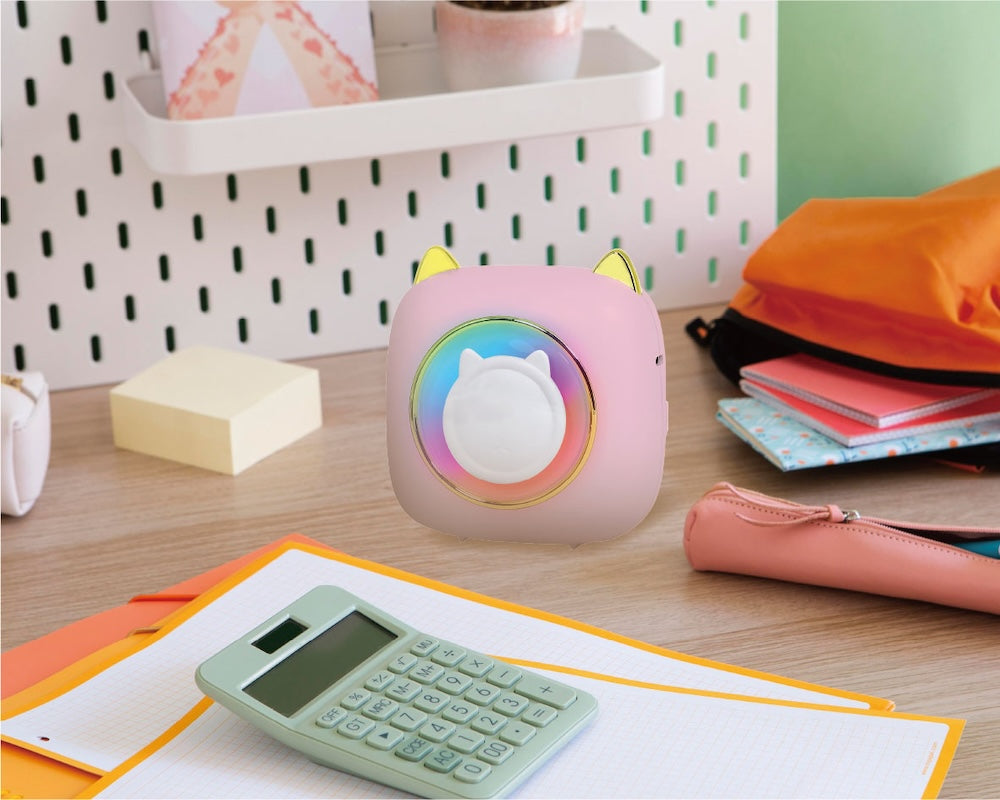 Artikl Pink Kitty Portable Thermal Printer on a study desk with notebooks and a calculator, highlighting inkless printing for notes, labels, and journaling