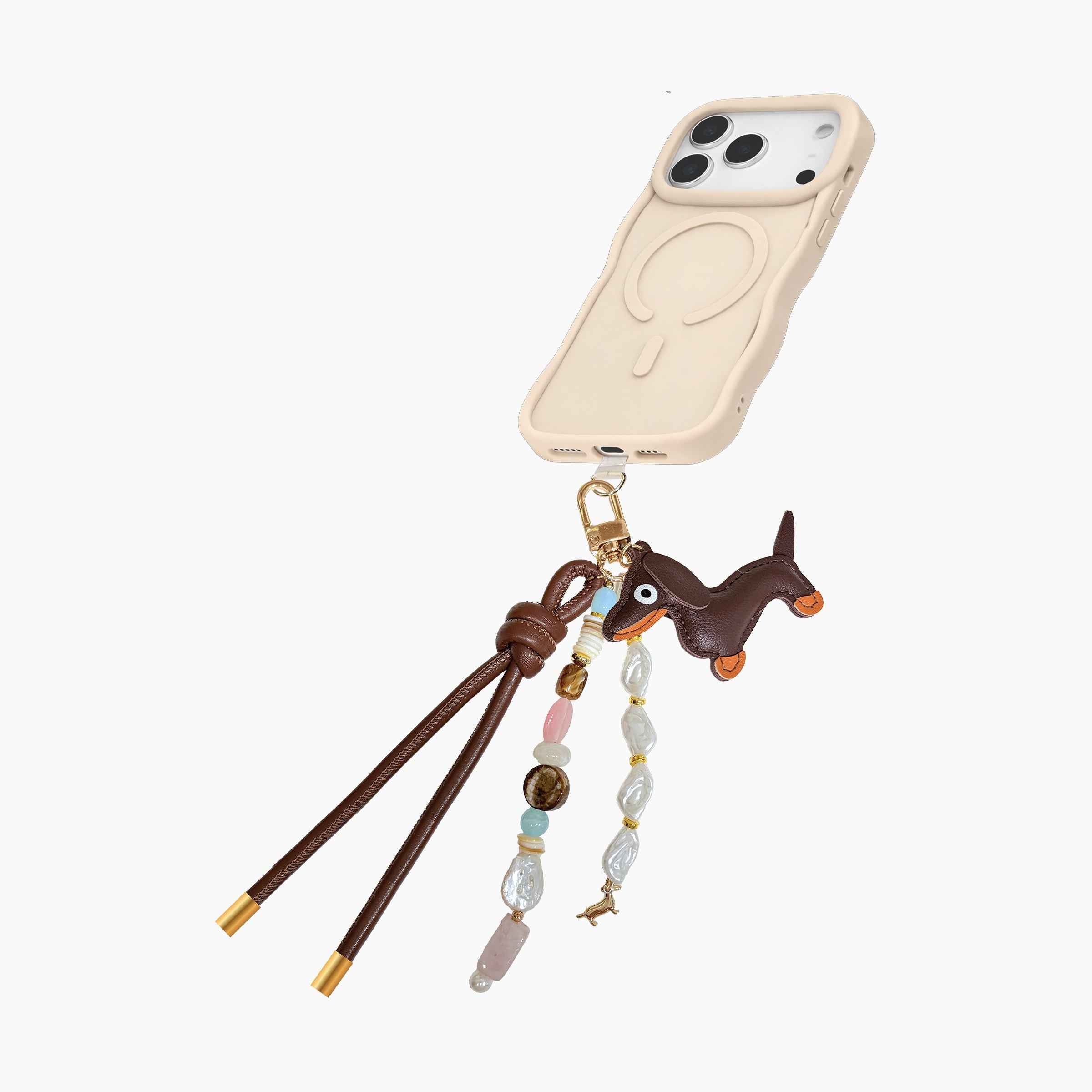 Dachshund-inspired phone charm attached to MagSafe phone case featuring leather dog pendant, gemstone-style beads, pearl accents, and decorative tassel details