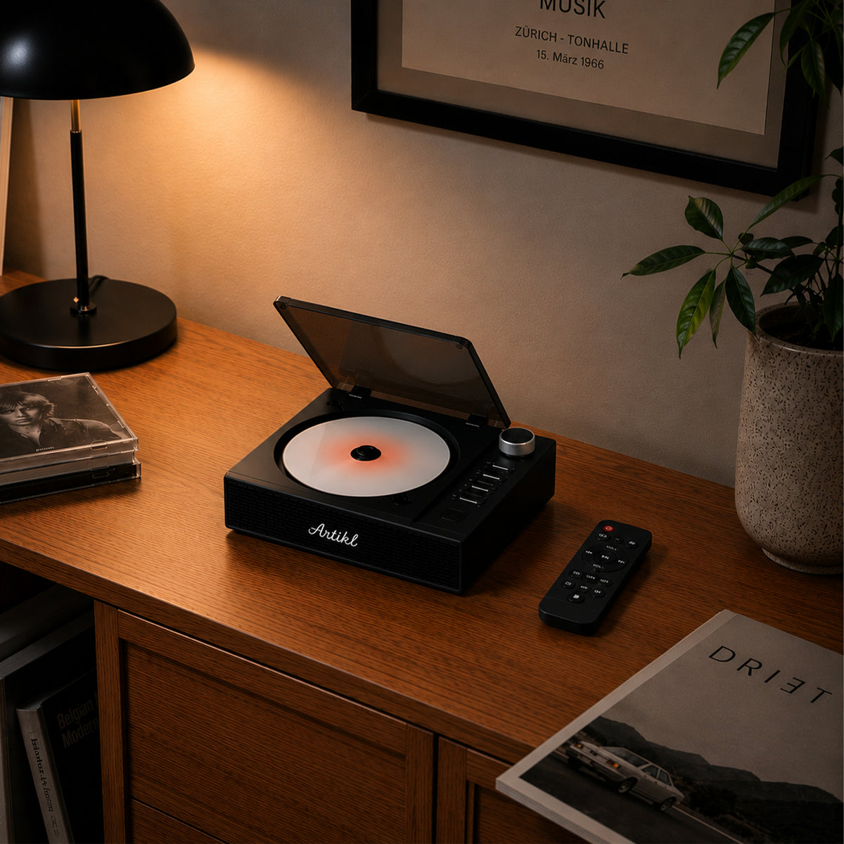 Artikl Portable Bluetooth CD Player in Black on a wooden desk beside a lamp, highlighting a cozy evening music setup at home
