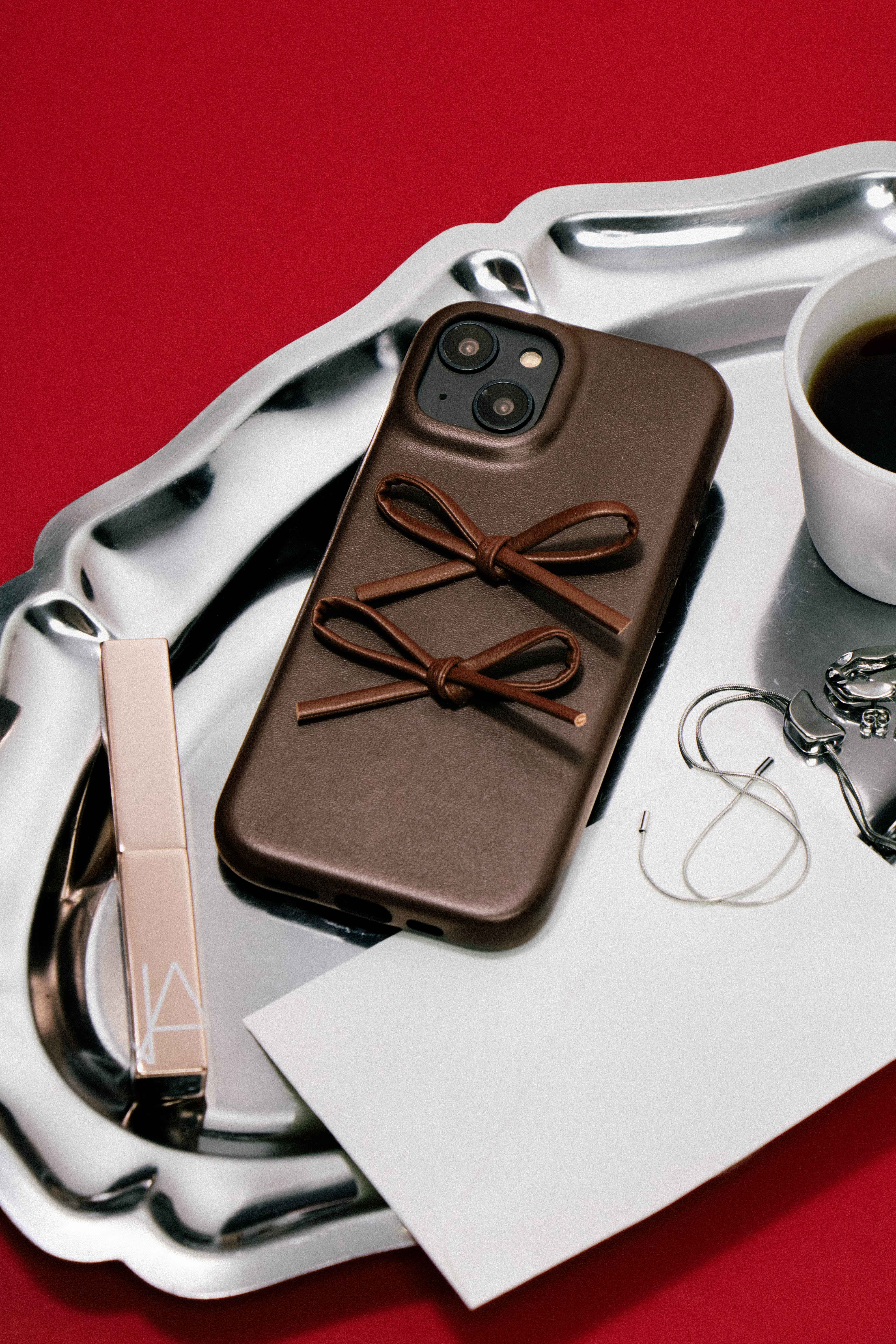 Chocolate Brown Ribbon Bow Phone Case for iPhone 16 Pro Max with decorative bow details, leather-inspired finish, and fashion-forward smartphone styling