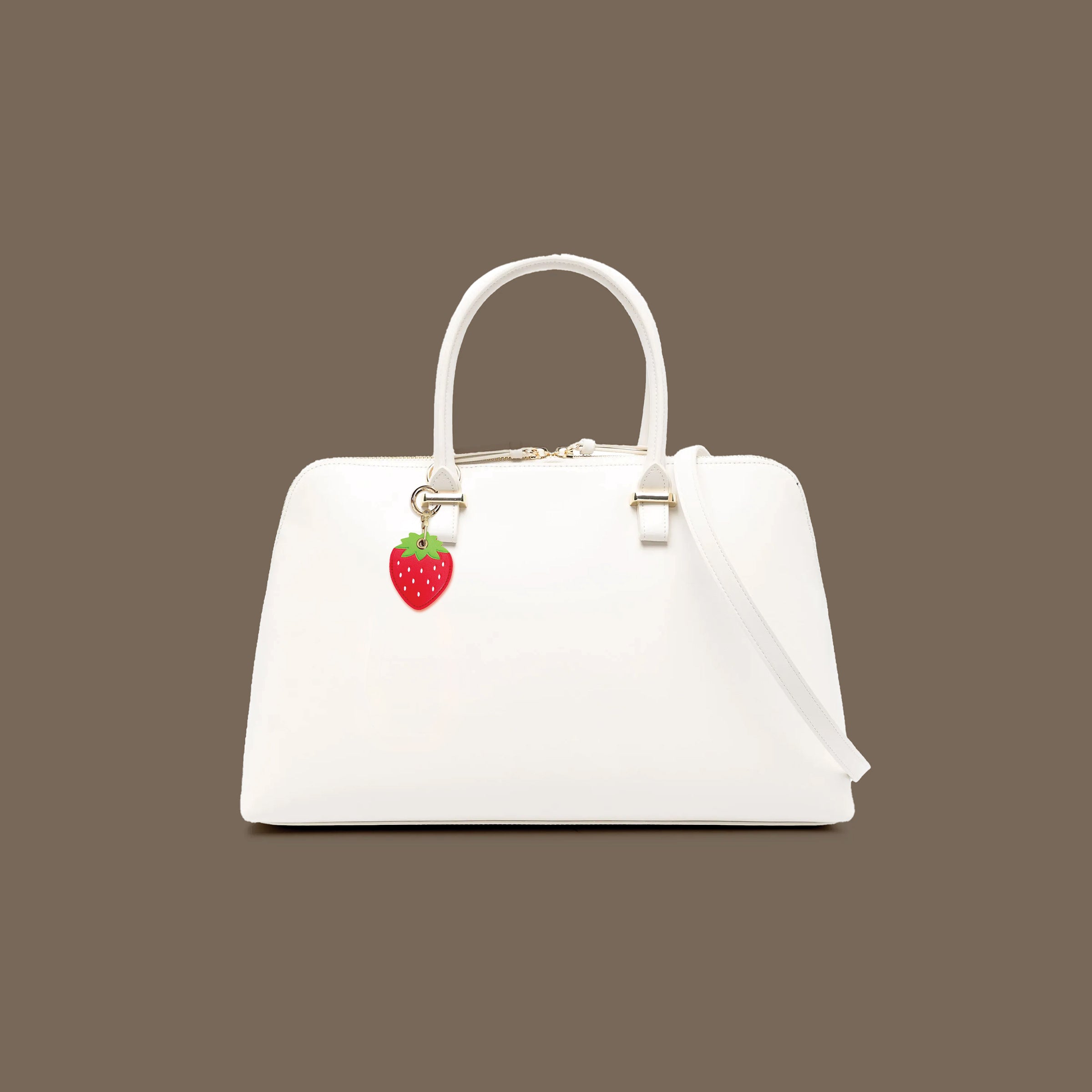 White handbag with a strawberry charm