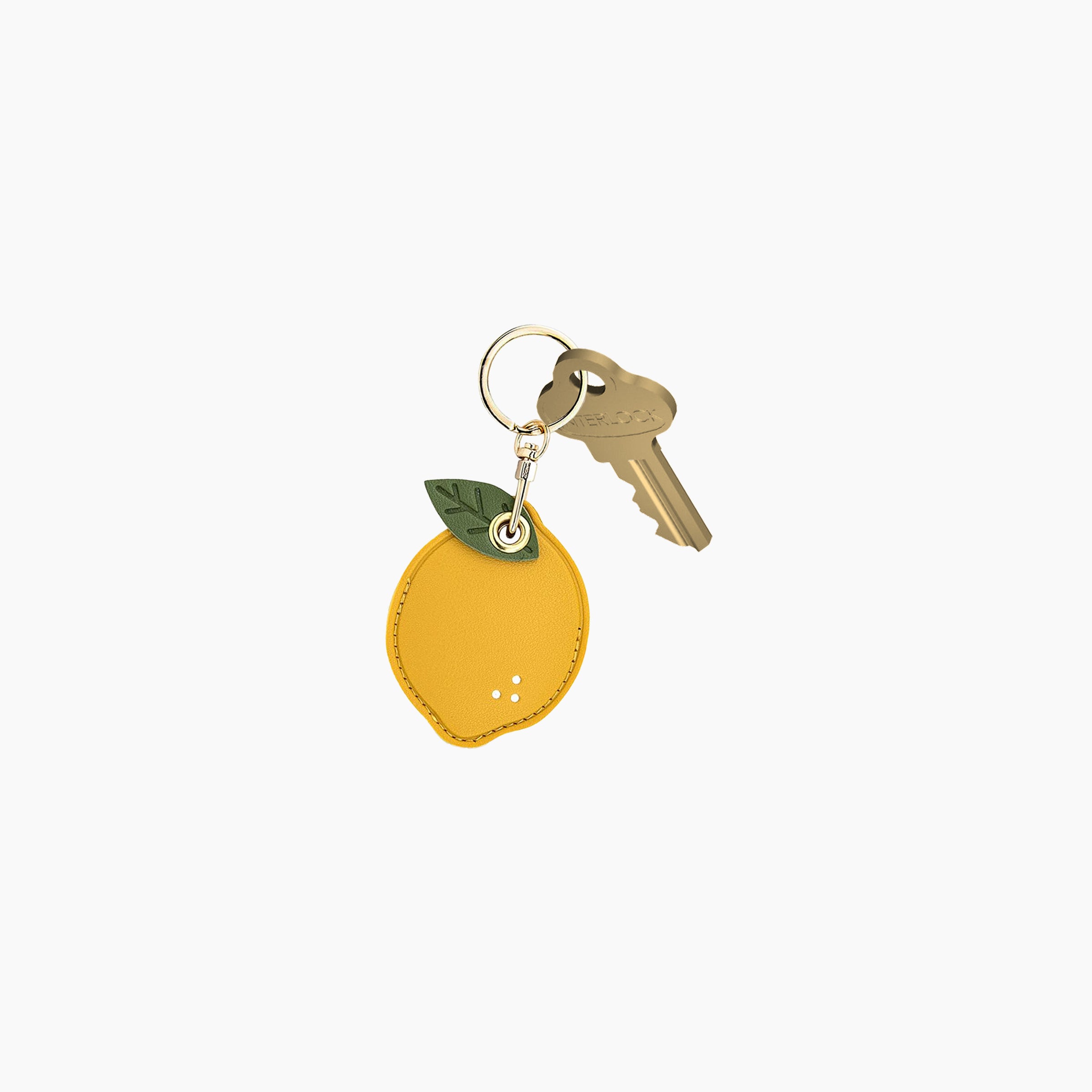 Keychain shaped like a lemon with a key on a white background