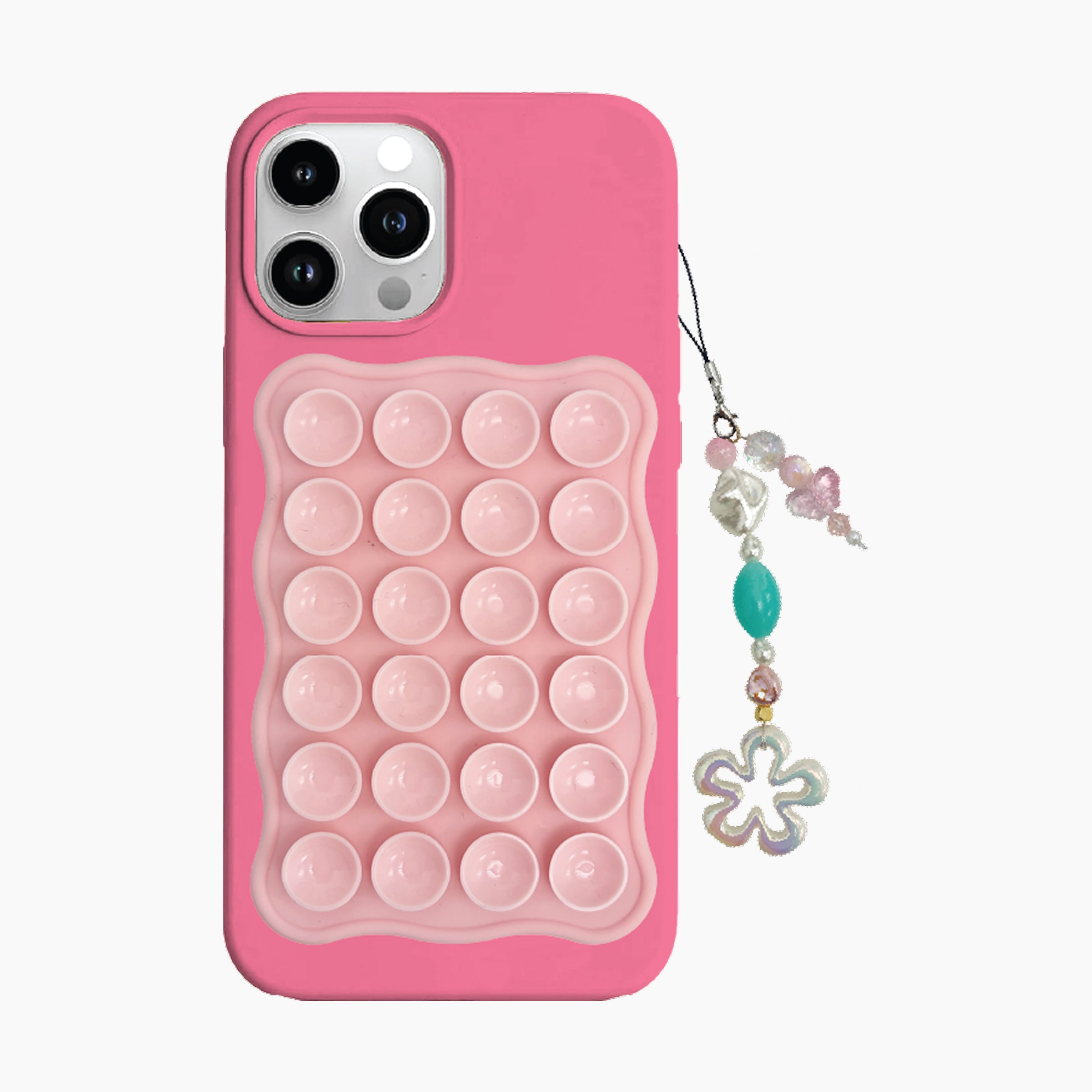 Pink phone case with bubble texture and decorative charm on a white background