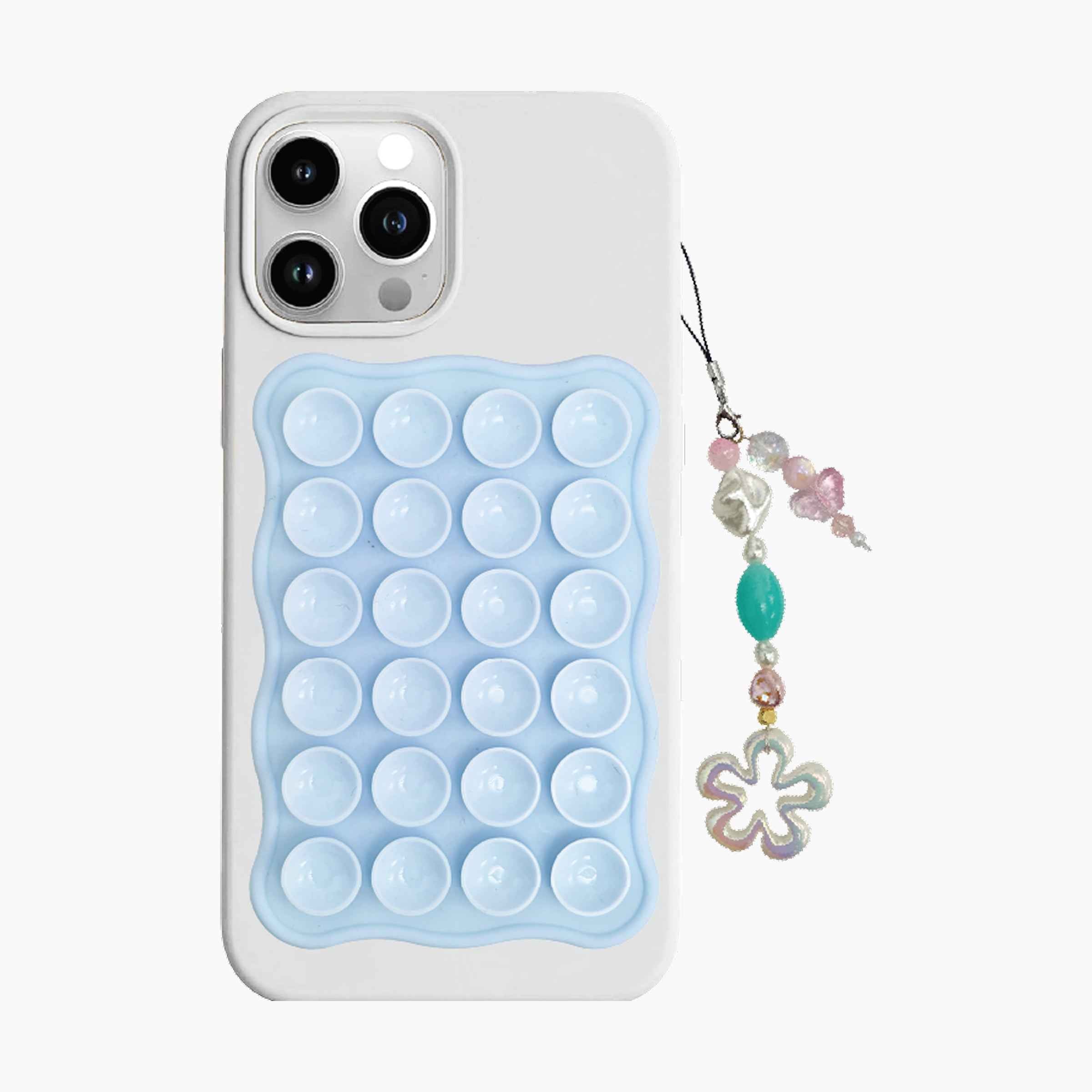 Blue suction phone mount attached to smartphone with decorative beaded phone charm featuring floral pendant and pastel gemstone-style accents