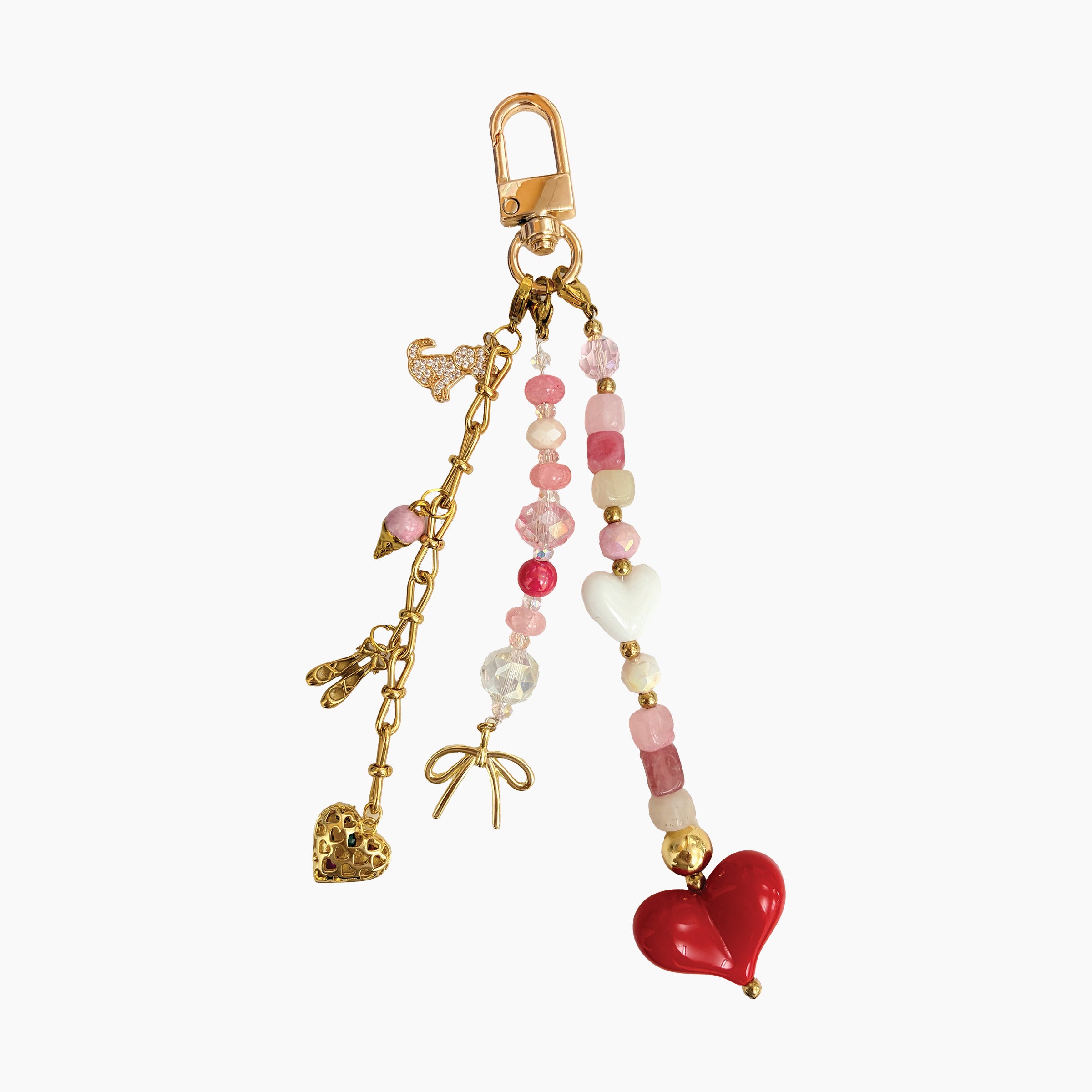 Keychain with gold chain, pink beads, and heart charms on a white background