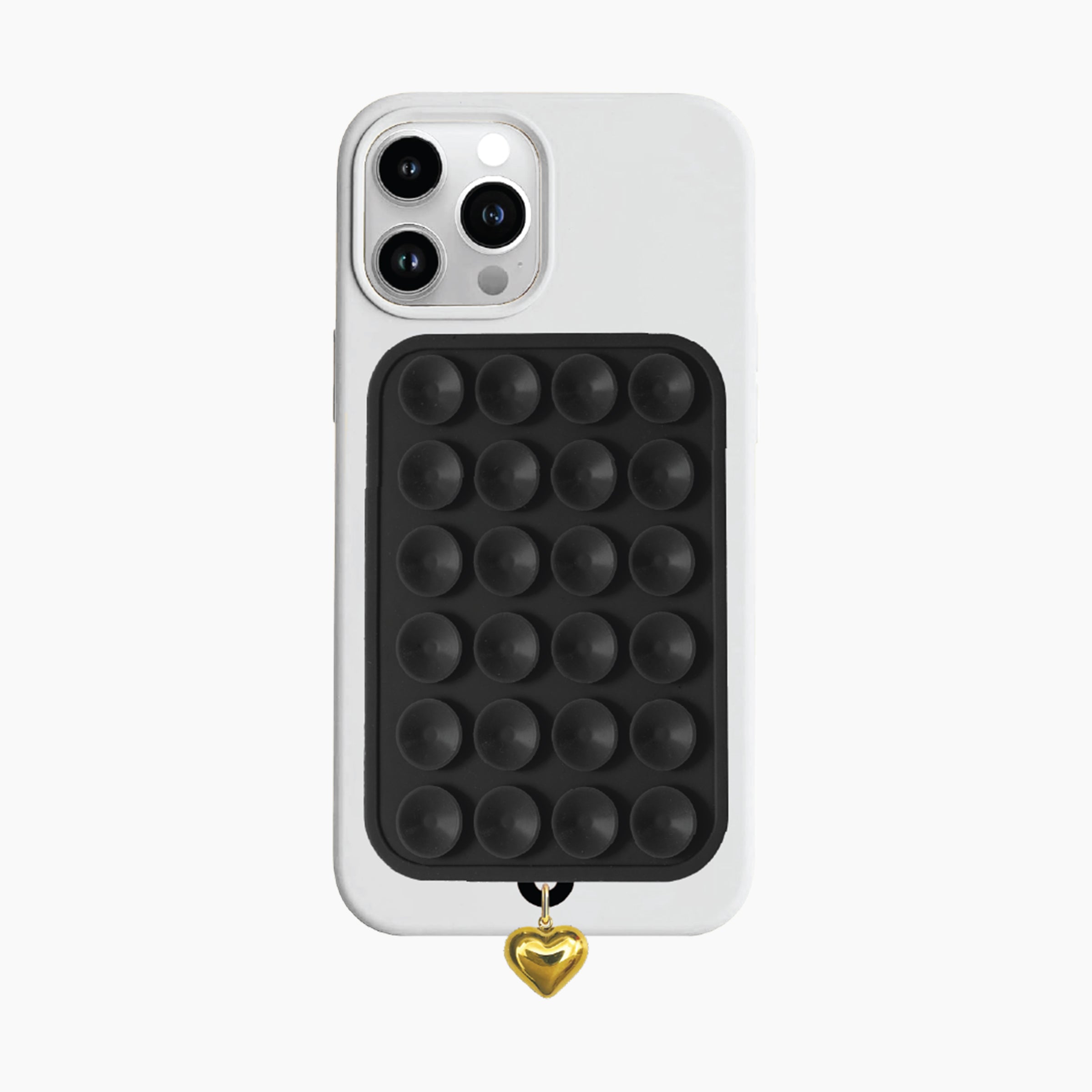 Artikl Snug Magnetic Phone Grip with Gold Heart Charm in Black, attached to the back of a phone