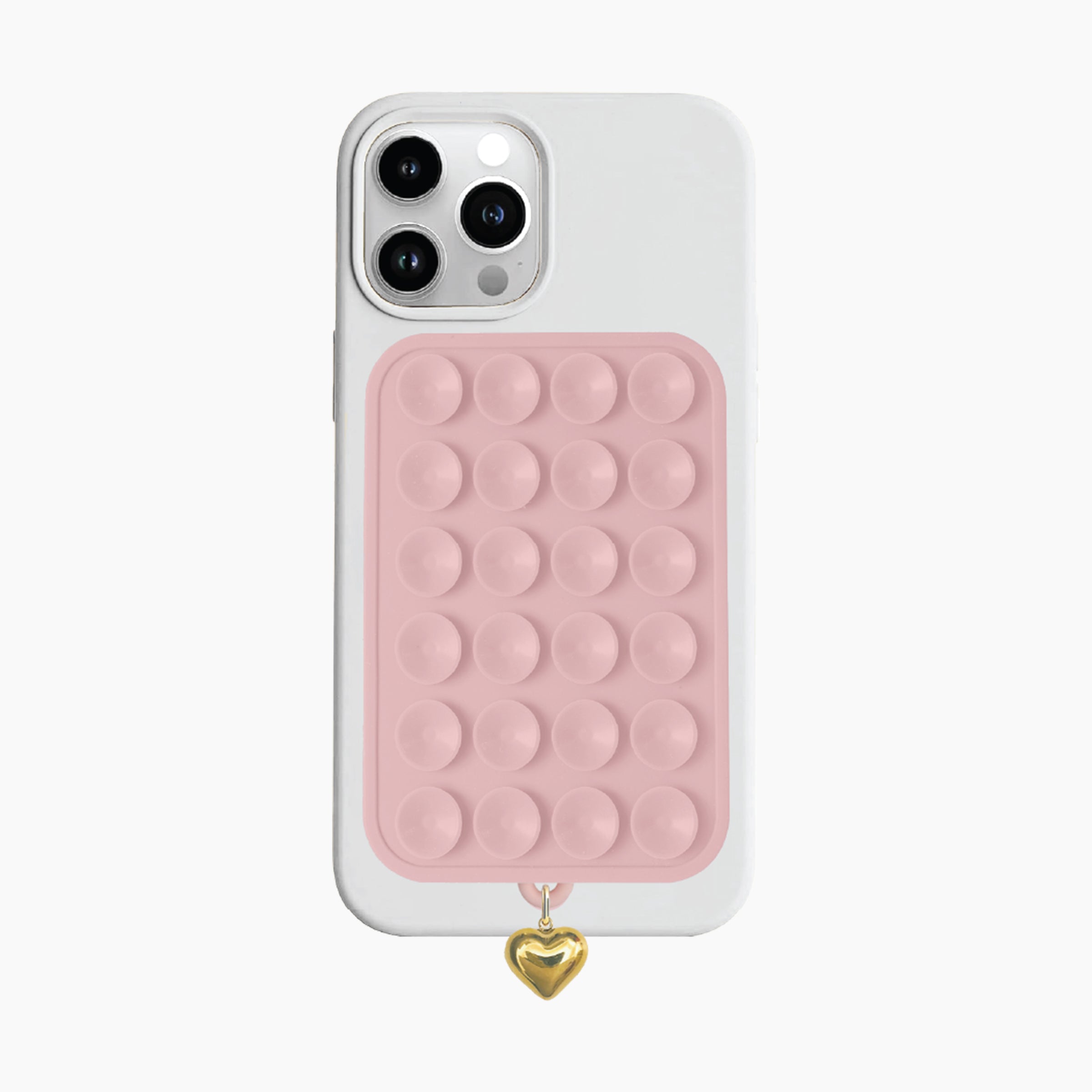 Artikl Snug Magnetic Phone Grip with Gold Heart Charm in Blush Pink, attached to the back of a phone