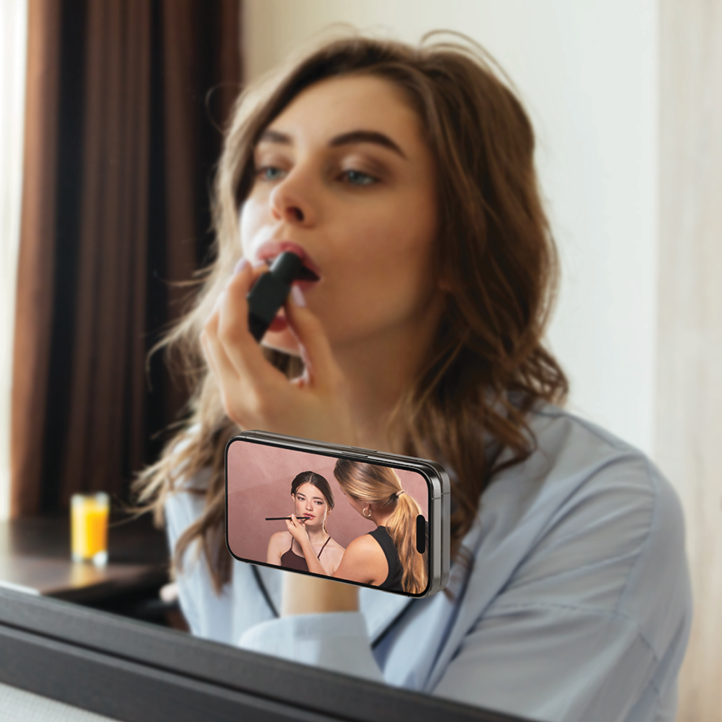 Snug Magnetic Phone Grip with Gold Heart Charm in use, woman applying lipstick while holding phone with grip attached in front of a mirror
