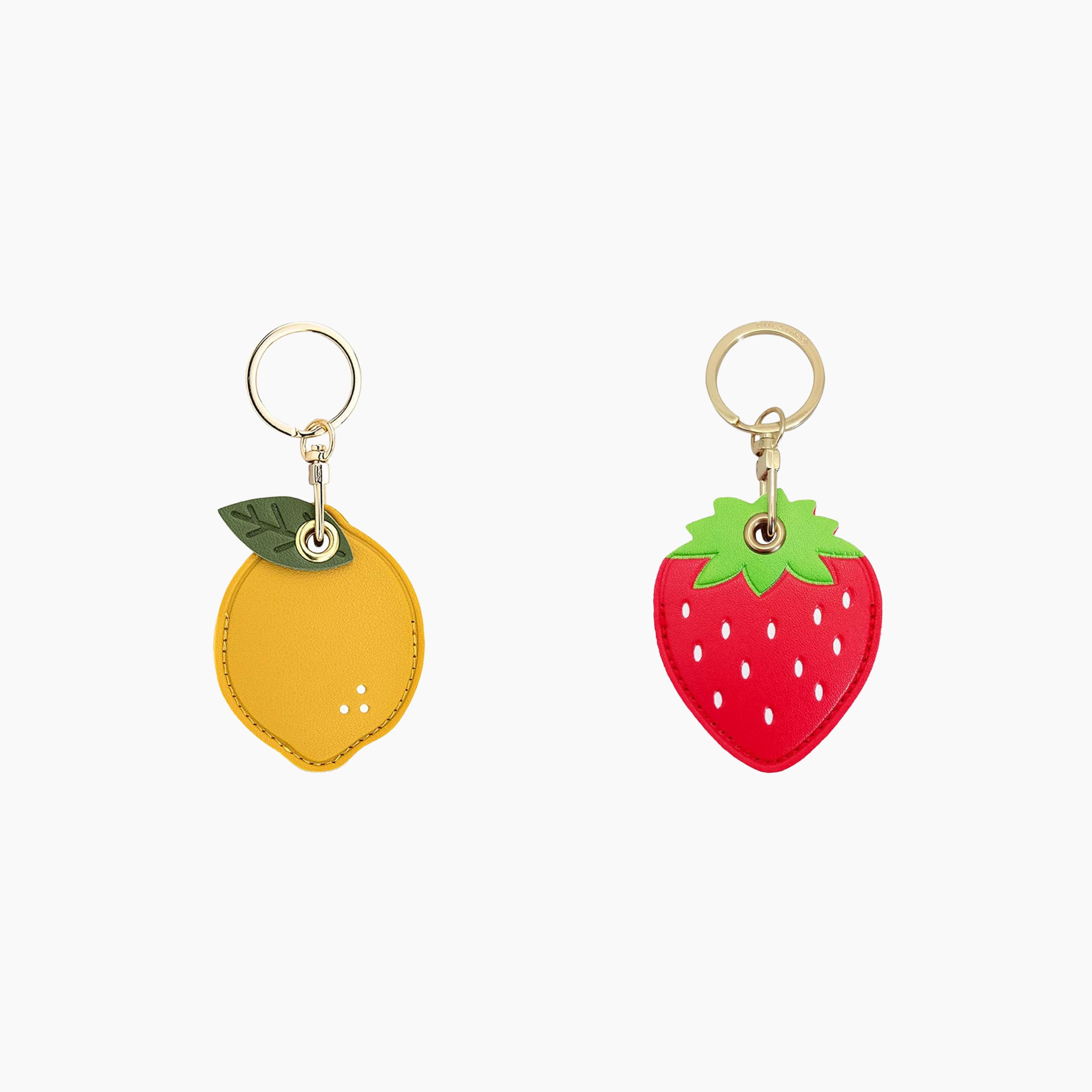 Fruit leather AirTag holder keychain set featuring lemon and strawberry designs with gold key rings