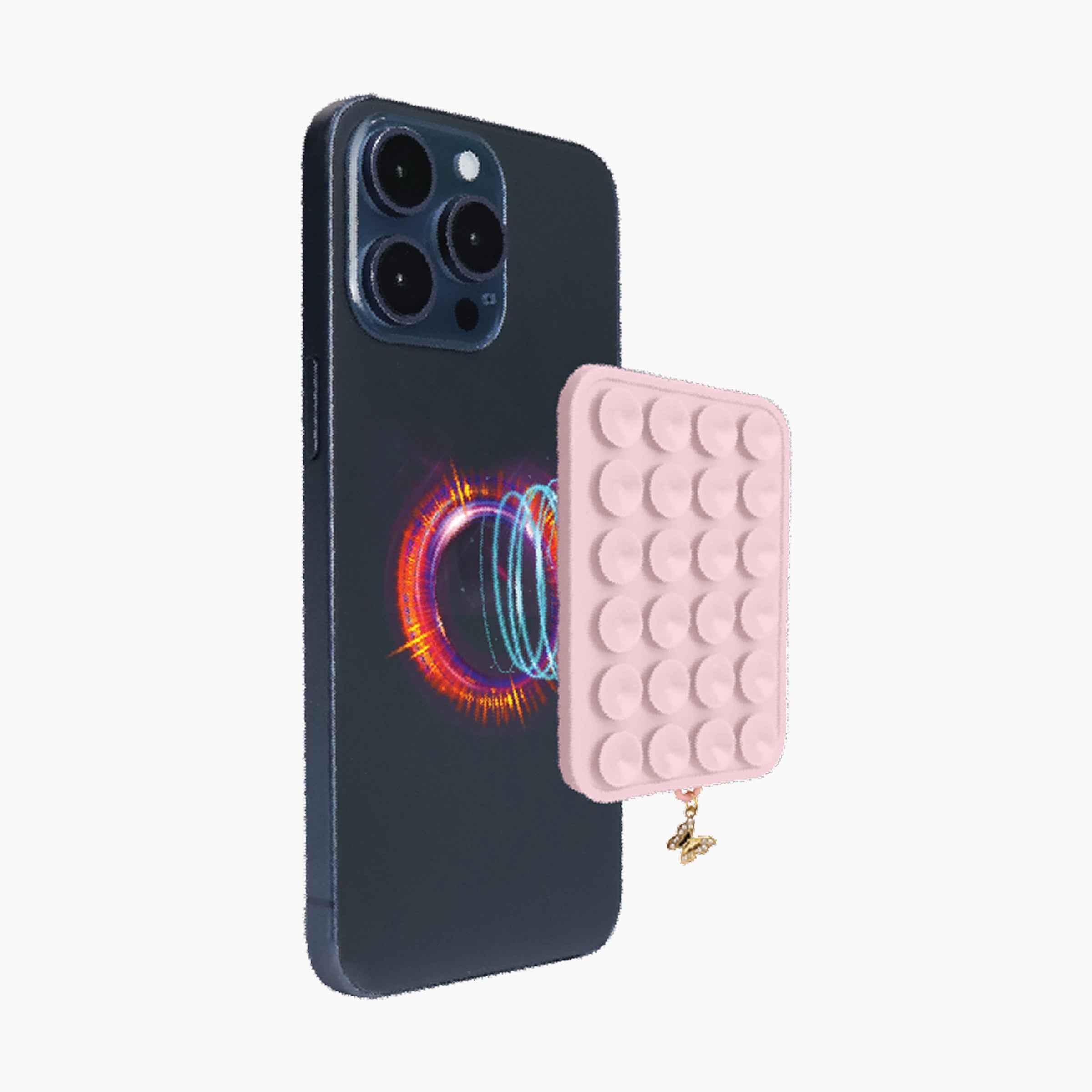 Pink magnetic suction phone mount attached to smartphone with reusable suction grip pad and butterfly charm